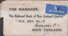 141251  1953 CLOTH BANKERS TAG SENT AIR MAIL LONDON TO AUCKLAND, NEW ZEALAND WITH BLOCK OF FOUR KGVI £1 BROWN (SG512).