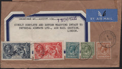 142016 1935 LARGE PART PARCEL WRAPPER AIR MAIL LONDON TO ASSIUT, EGYPT WITH SEAHORSES 5S (SG451), 10S (SG452) ALSO 5D , 9D AND 10D ISSUES.